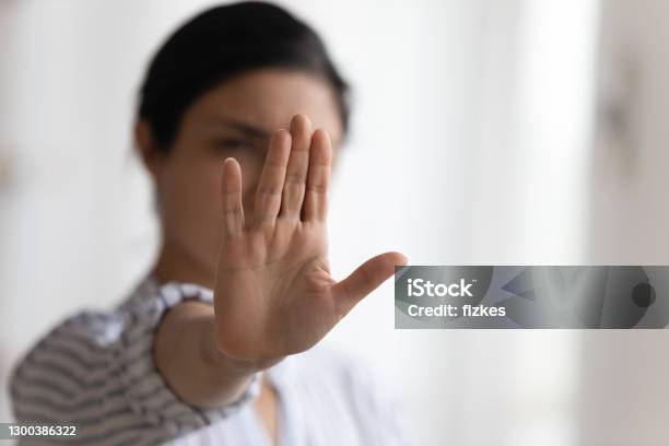 Focus On Female Palm Raising Up In Stop Gesture Stock Photo - Download Image Now - Rebellion, Stop Sign, Women