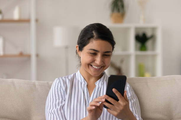 istock Happy young hindu lady enjoy reading news using web app 1300386336