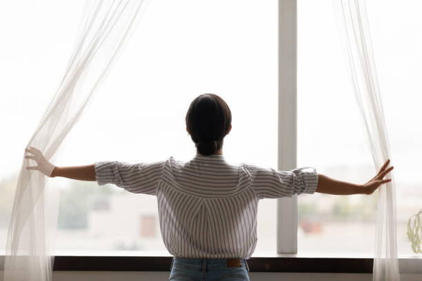 istock Millennial lady pull curtains back meet morning aim for positive 1300386337
