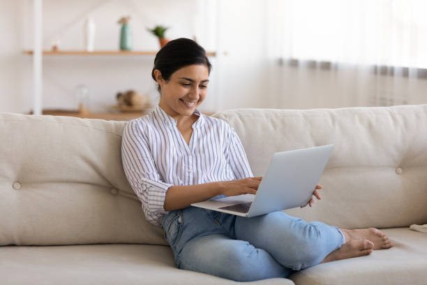 istock Young mixed race lady resting at home by pc screen 1300386357