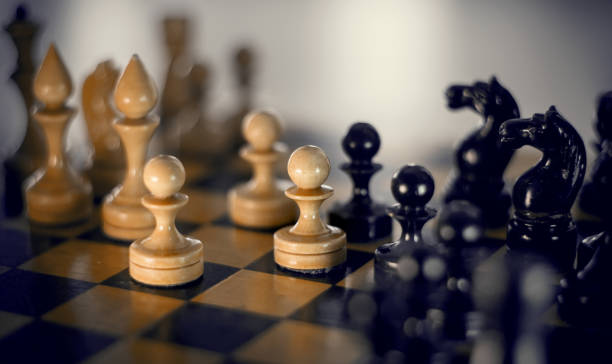 istock Wooden chess pieces on the chessboard. 1300387214