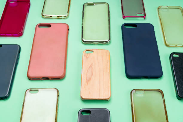 istock Pile of multicolored plastic back covers for mobile phone. Choice of smart phone protector accessories on green background. A lot of silicone phone backs or skins next to each other 1300388639