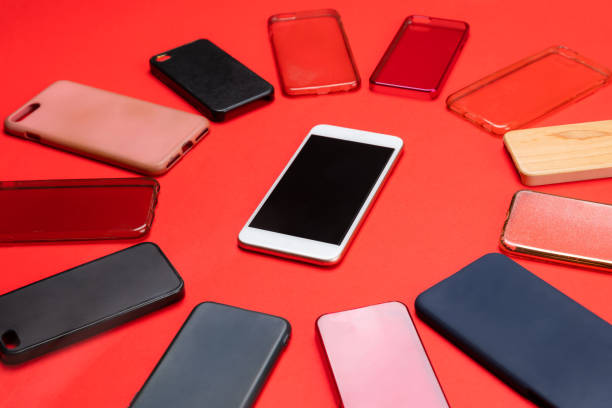 istock Choice of multicolored plastic back covers for mobile phones on red background with a smart phone on the side 1300388697