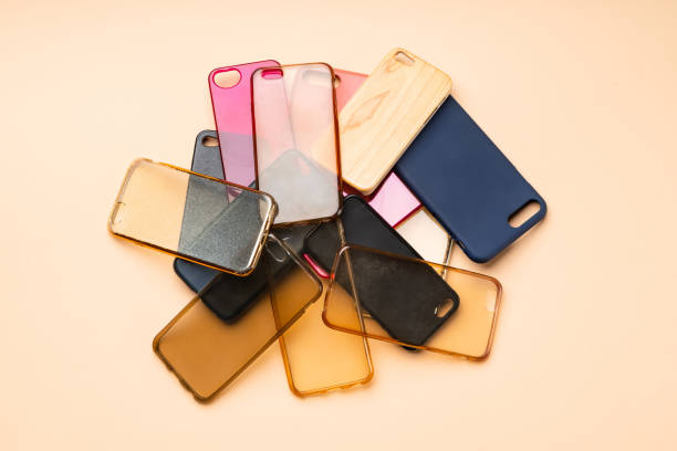 istock Pile of multicolored plastic back covers for mobile phones on neutral background 1300388790