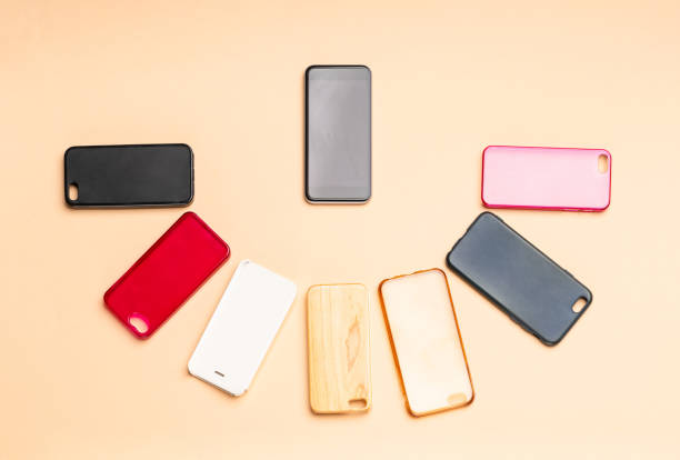 istock Choice of multicolored plastic back covers for mobile phones on neutral background with a smart phone on the side 1300388800