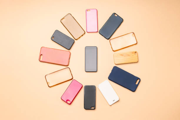 istock Choice of multicolored plastic back covers for mobile phones on neutral background with a smart phone on the side 1300388817