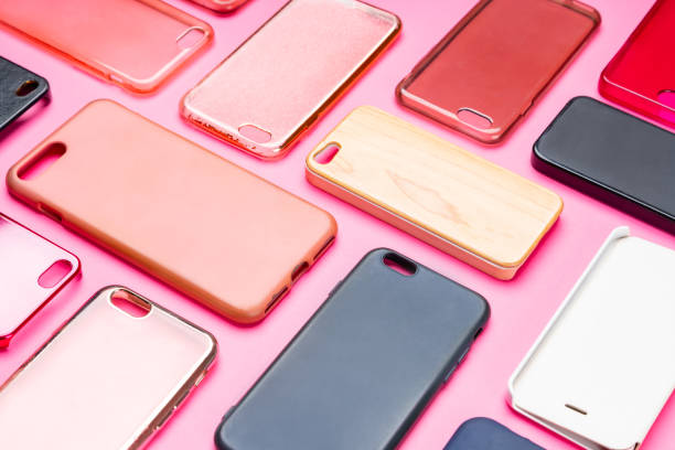 istock Pile of multicolored plastic back covers for mobile phone. Choice of smart phone protector accessories on pink background. A lot of silicone phone backs or skins next to each other 1300388832