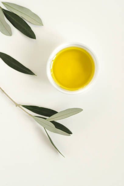 istock Olive branches and olive oil white background, minimalism style, copy space 1300392207