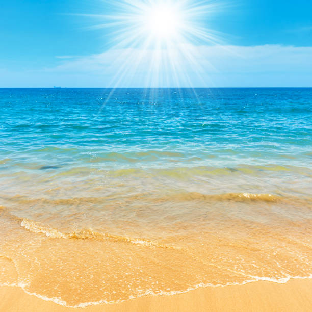 istock Blue sea water and sand beach 1300392843