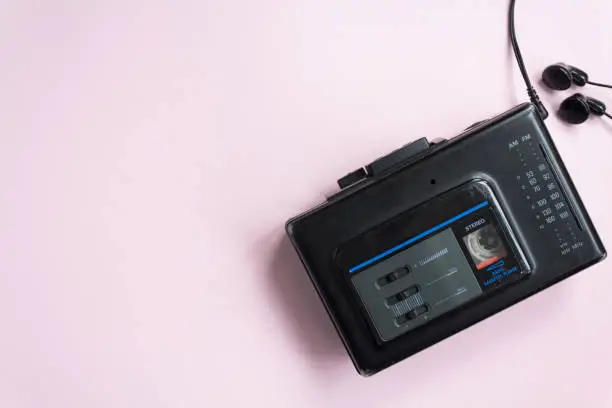 Top view of old walkman on pink background with copy space