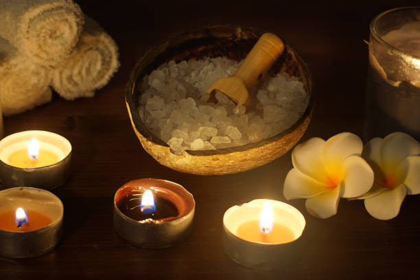 istock White sea bath salt in a coconut shell next to burning candles on the table 1300394000
