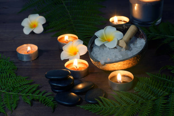 istock Black stones for hot massage on a table surrounded by burning candles 1300394031