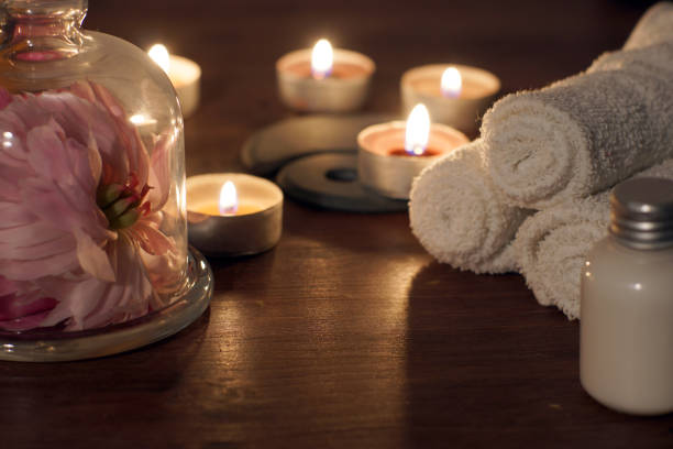 istock Pink peony flower under a transparent cap and burning candles in spa composition 1300394067