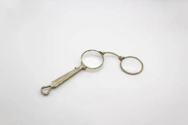 Photo of Old vintage lorgnette from the middle of the nineteenth century on the white background