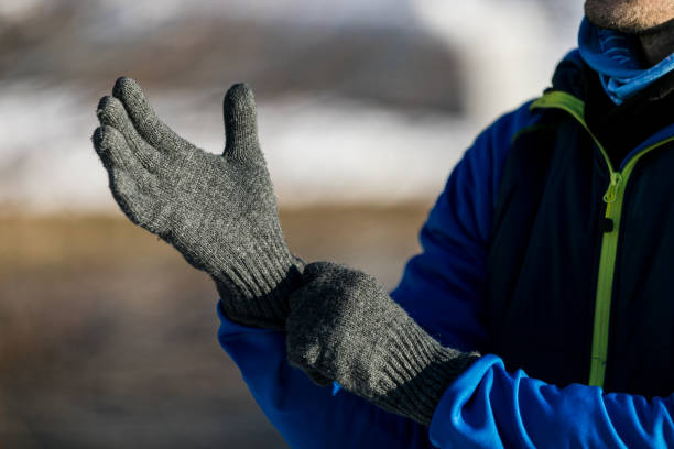 istock Man putting winter gloves on 1300396071