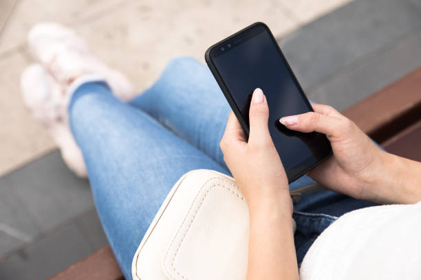 istock woman holding phone 1300398086