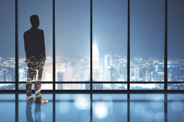 istock Businessman standing in contemporary office 1300398791
