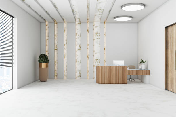 istock Bright hotel hall with reception table, computer, plant and citi view. 1300398851