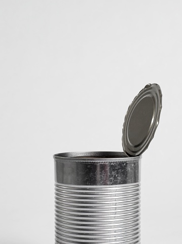 Monochrome image of opened soup can with white background.