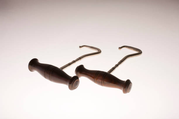 Pair of sharp hooks with wooden base isolated on white background