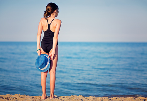 Teenage girl is enjoying the ocean view