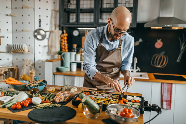istock Young man grilling vegetables on electric barbecue grill 1300405048