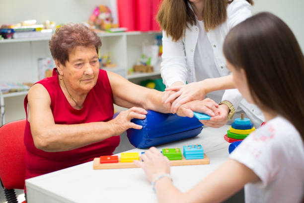 istock Old woman on physical therapy after suffering from stroke 1300406860