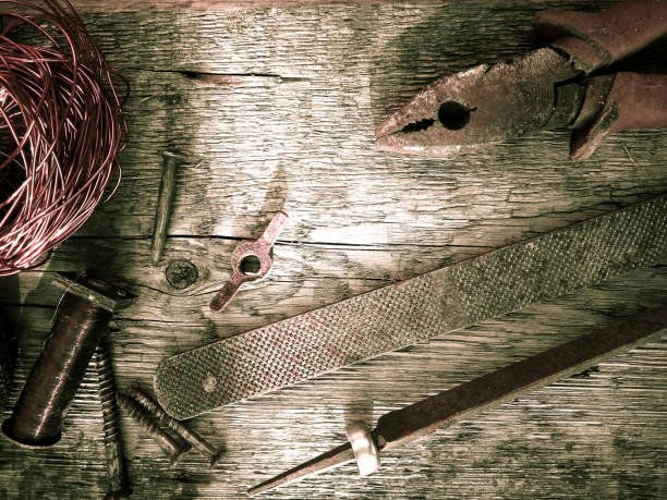 Different  nails and copper wire  on a wooden background.  Top view . Place for text. Vintage elements.