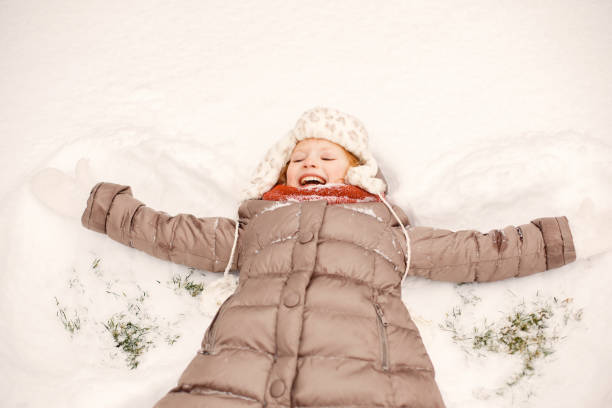 istock Cute little girl in a winter park 1300407002