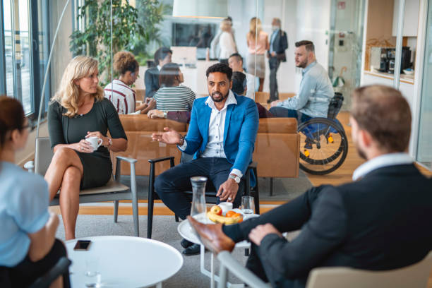 istock Business Groups Talking in Modern Office Lobby 1300410129