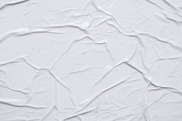 istock Blank white crumpled and creased paper poster texture background 1300410196
