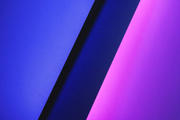 istock Blank paper sheets rolled in a neon purple lighting 1300410804