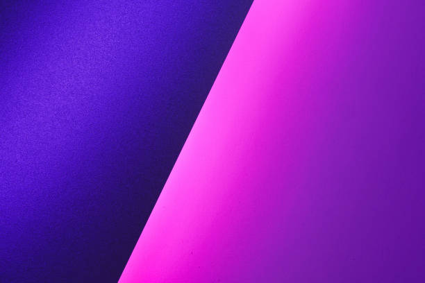 istock Blank paper sheets rolled in a neon purple lighting 1300410970