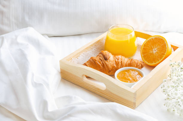 istock Breakfast in bed with orange juice on wooden tray. 1300412100