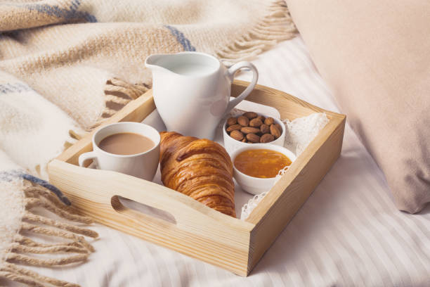 istock Breakfast in bed with croissant on wooden tray. 1300412103