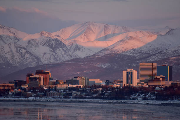 Anchorage, Alaska, at sunset The setting sun paints Anchorage, Alaska, a pastel pink in a phenomenon called alpenglow. anchorage alaska photos stock pictures, royalty-free photos & images