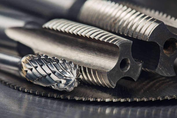 istock set of different drill bits,thread tap and mill cutters with caliper ruler on steel plate background. Locksmithing deal. 1300418060