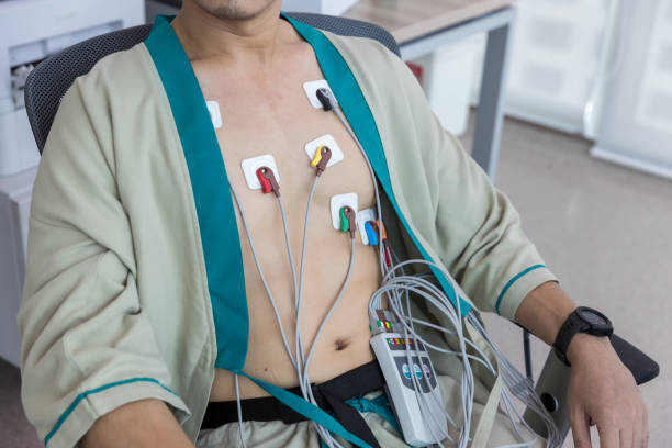 herzelektrokardiogramm oder überwachung mit holter für junge patienten. männliche sportler macht einen herz-stress-test. holter monitorgerät zur täglichen überwachung eines elektrokardiogramms. - pulse trace arrhythmia electrode listening to heartbeat stock-fotos und bilder