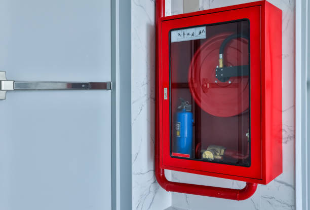 istock Hydrant with water hoses and fire extinguish equipment. Fire safety equipment in the red box on wall cement . Hydrant with water hoses and fire extinguish equipment / fire hose box . 1300422404