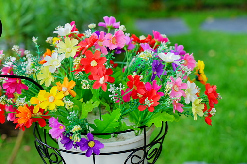 Close-up Colorful artificial flower bouquet decorated in basket