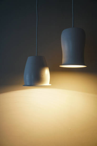 istock Two hanging lighted lamps with ceramic plafonds 1300424055