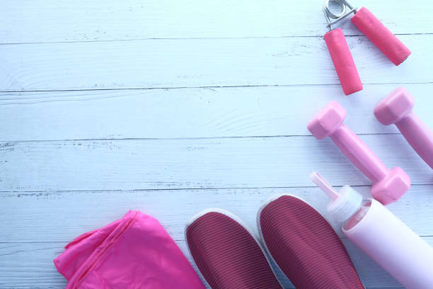 istock pink color dumbbell, exercise mat and water bottle on white background 1300424788
