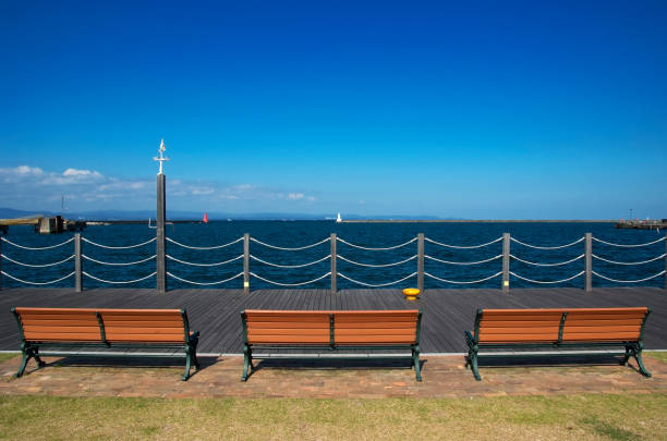 istock Three bench in front of the sea against clear sky 1300425640