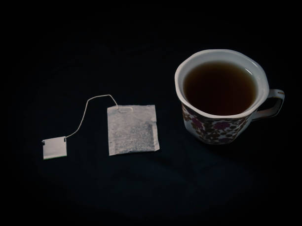 istock Tea and sugar isolated on black background 1300427201