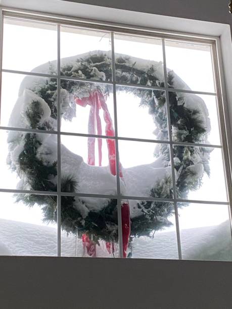 istock Christmas Wreath in Paned Window 1300430450