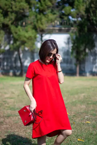 Chinese New Year girl hold glasses and bag