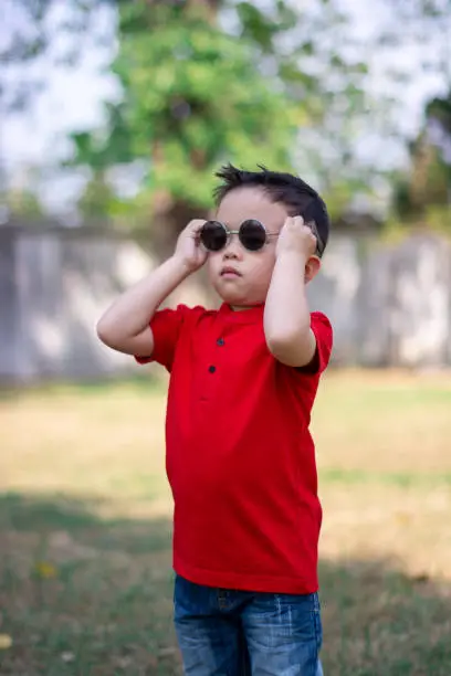 Chinese New Year Boy two hands at Sun glass