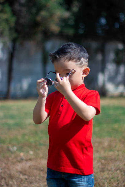 istock Chinese New Year Boy take off Sun glass 1300434151