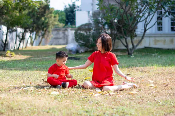 Chinese New Year Boy and mommy sitting on the ground
