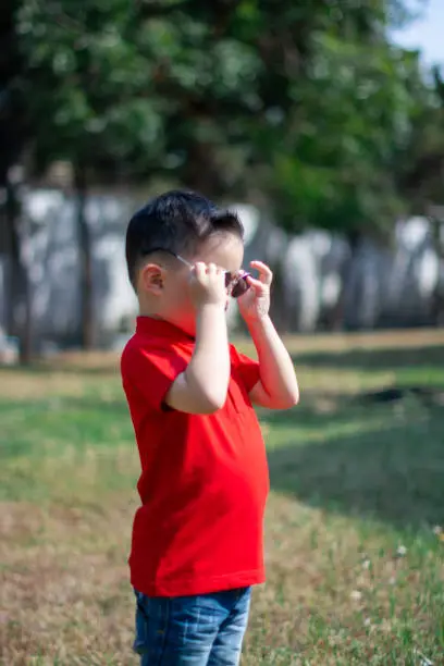 Chinese New Year Boy hold Sun glass